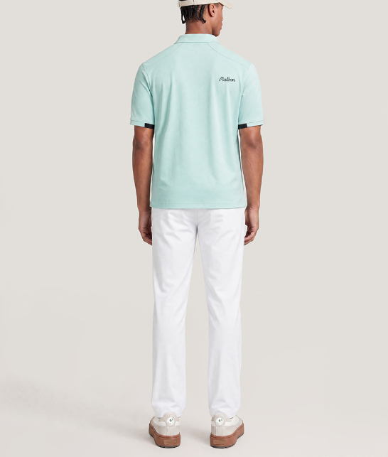 Model wearing Malbon beige dot print golf polo
