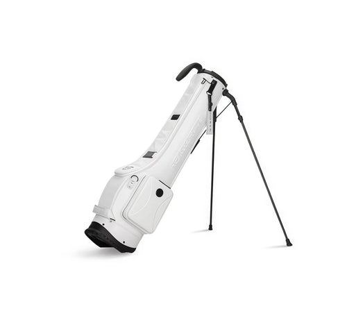 White HELIX B-Series golf stand bag on black tripod legs with padded top handle and front zipped pocket