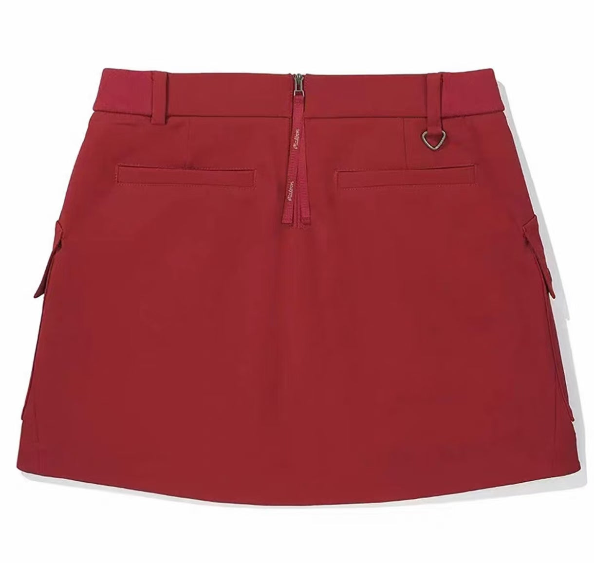 Malbon women's solid pleated golf skort with pockets in Red, detail view