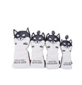 Front view of a four-piece black and white Akita Inu golf headcover set featuring cartoon-style dog faces with expressive eyes and paws, labeled "HELLO NRC AKITA DOG" — ideal for driver, fairway, hybrid, and utility clubs.