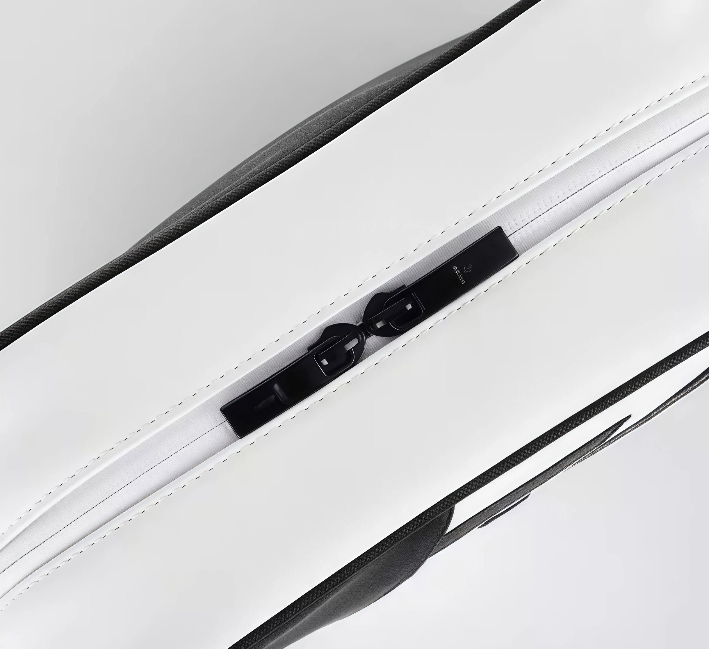 Close-up of the zipper and fabric texture on the European Tour golf pouch. Features a smooth black zipper pull with subtle branding and clean white stitching.
