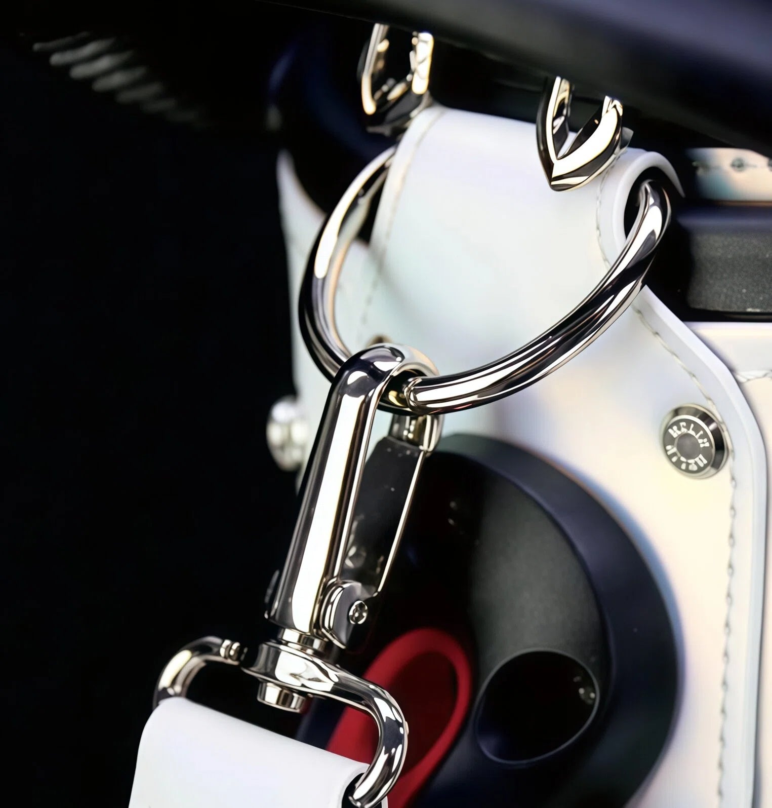 Detail shot of the HELIX Vibe Collection golf bag’s premium chrome-plated carabiner clip and reinforced carry strap, offering secure attachment and easy transport.