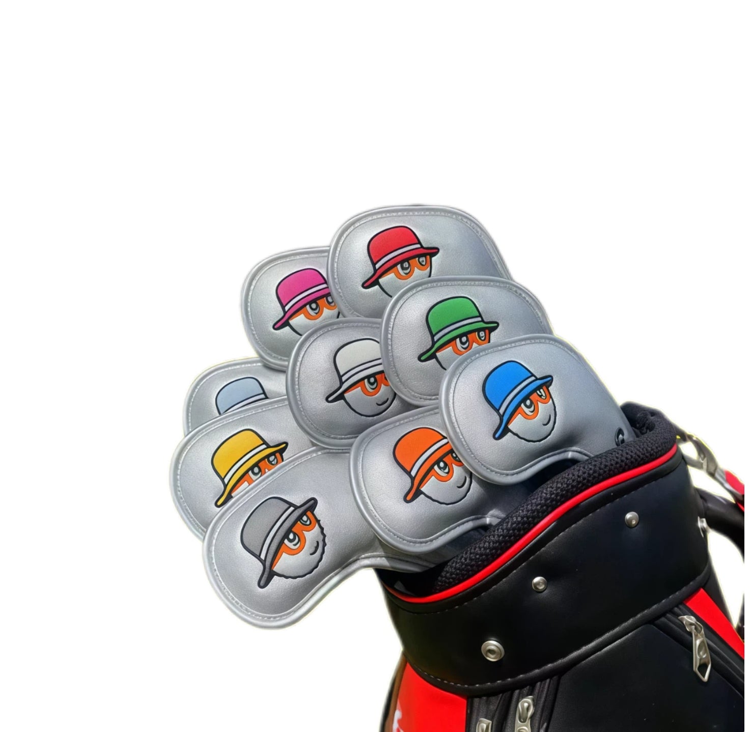 Silver metallic Malbon-style golf iron covers showcasing cartoon faces with orange-tinted glasses and assorted hat colors; arranged in golf bag to highlight sleek finish and durable magnetic closure mechanism.