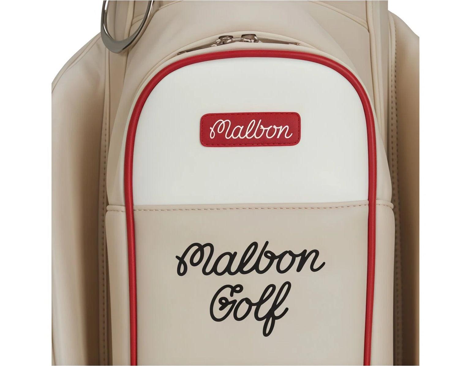 Top-down view of Malbon Golf bag back panel showing red "Malbon" patch and black cursive "Malbon Golf" text. Premium detailing with contrasting red trim for visual appeal.