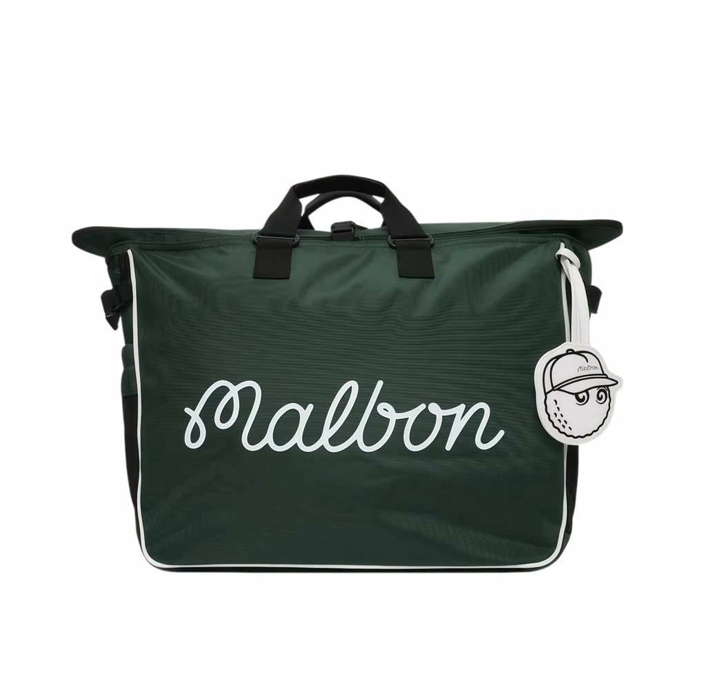 Full front view of Malbon Golf Heritage duffle bag in deep green featuring white cursive "Malbon" logo, black handles, and a playful golf ball-shaped tag
