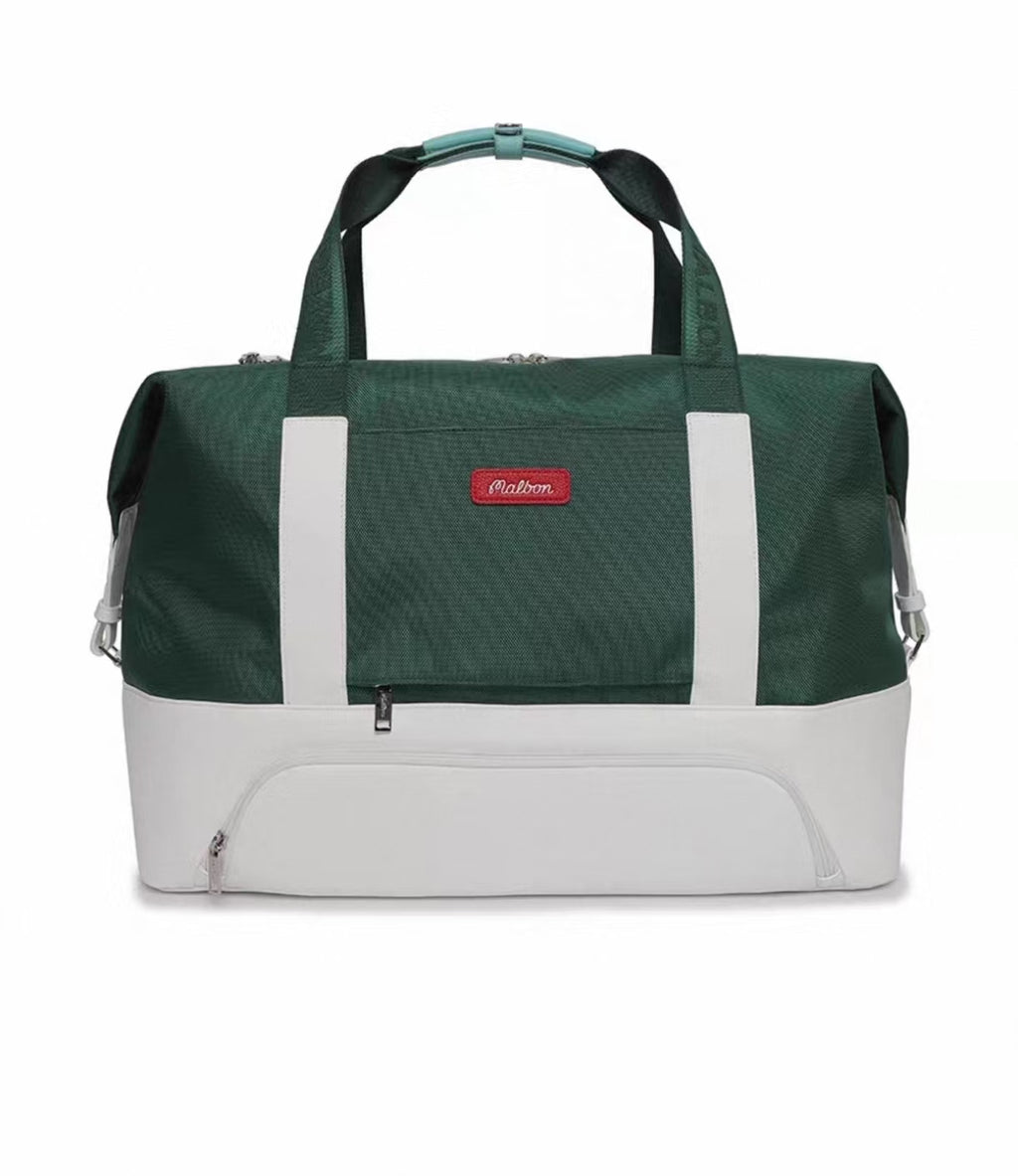 Front view of Malbon Golf Performance luxury duffel bag in deep green with white bottom panel, white side stripes, and red "Malbon" brand label

