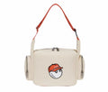  Front view of Malbon Golf small casual shoulder bag in cream PU leather with embroidered golf ball mascot wearing red "Malbon" cap, silver-tone zippers, and orange adjustable strap