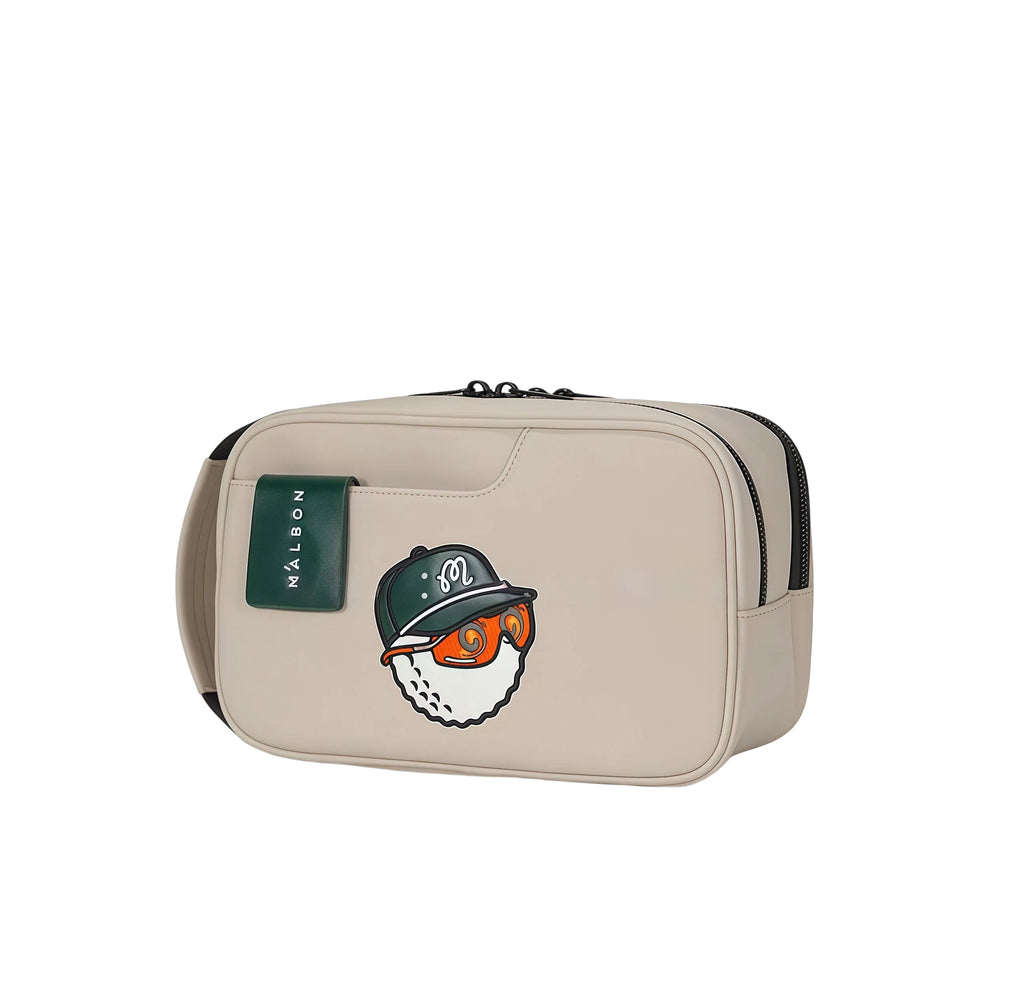 Beige Malbon golf handheld bag featuring a stylish green cap character patch and contrasting green brand tag. Lightweight and compact.
