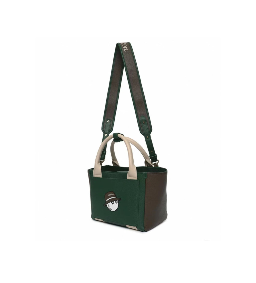 Side view of the Malbon clubhouse mini tote bag in green and brown color-block design. Features a structured silhouette, beige top handles, and an adjustable crossbody strap with "Malbon" script.
