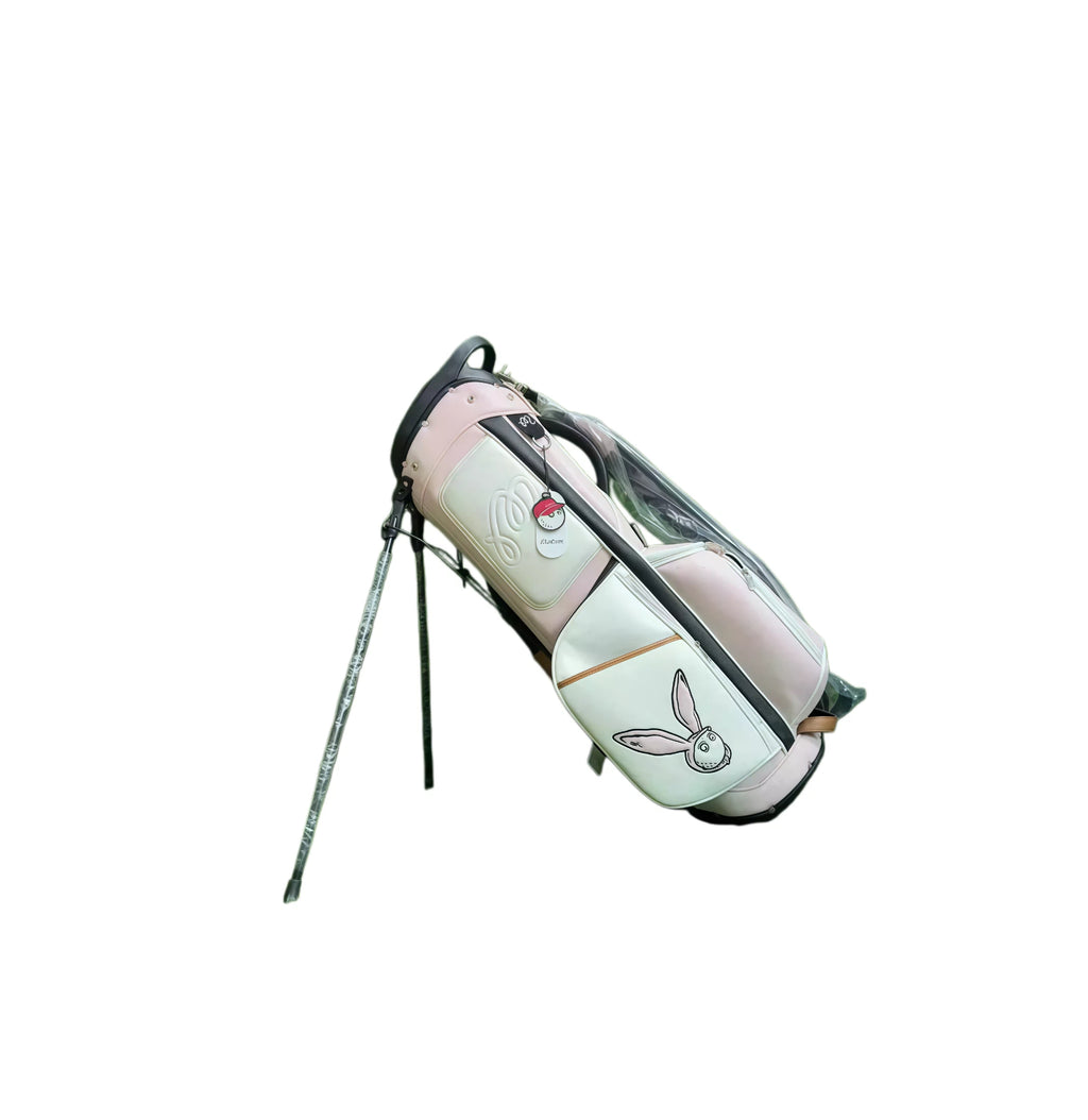 Malbon Pink Golf Stand Bag side view in white and pink with transparent rain cover, multiple storage pockets, and “MALBON” embossed logo - lightweight PU and nylon blend for outdoor use