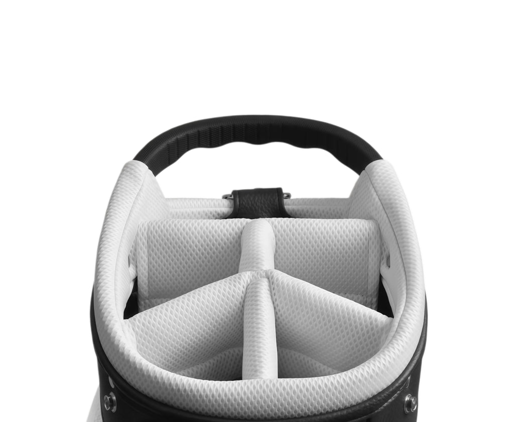 Top-down view of Malbon Roo King golf bag interior showing white padded club dividers, textured lining, and reinforced structure for optimal club protection.
