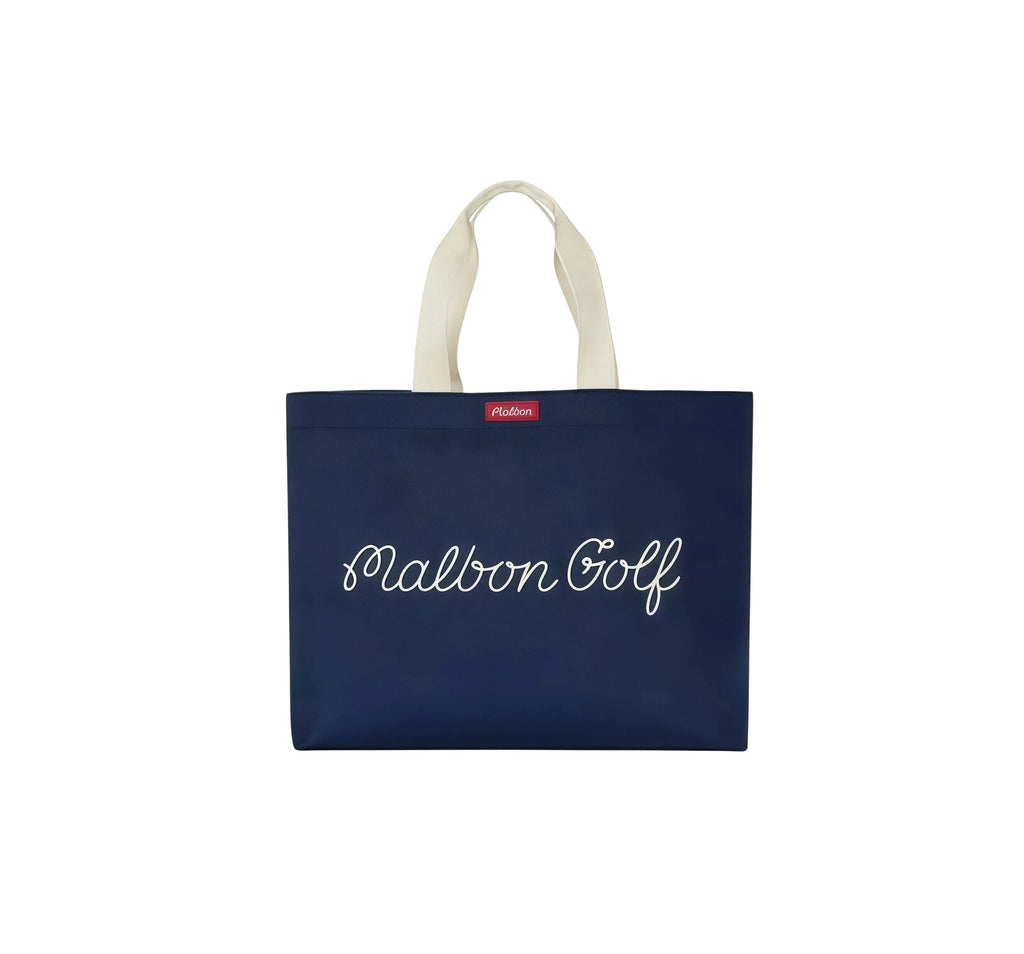 Navy blue Malbon Golf tote bag with white script "Malbon Golf" logo and red brand label, durable canvas design for golf essentials and daily carry.