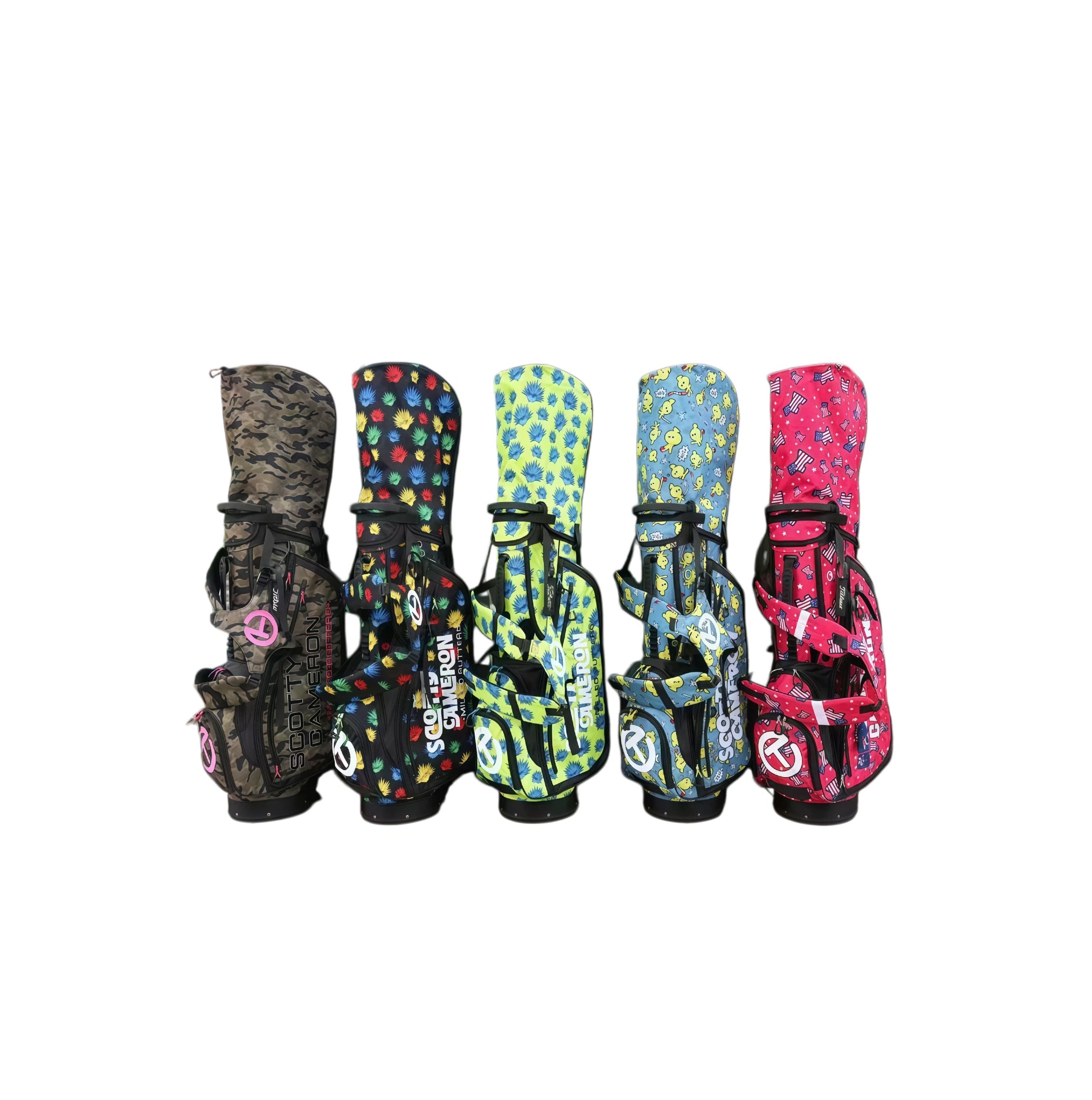  A front view of the Scotty Cameron Pathfinder Hometeam Stand Bag collection. Five bags are displayed, featuring unique and playful designs like camo, multi-colored pineapples, and a patriotic stars-and-stripes pattern.
