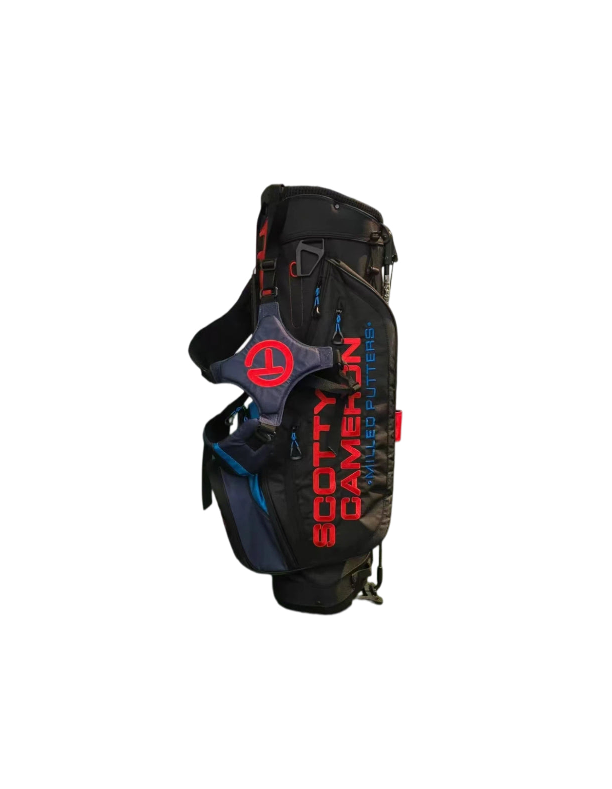 Angled view of the Scotty Cameron Pathfinder Stand Bag in Black, Red, and Blue, showcasing the bold "SCOTTY CAMERON MILLED PUTTERS" text, Circle T logo on the dual strap, and premium fabric construction.