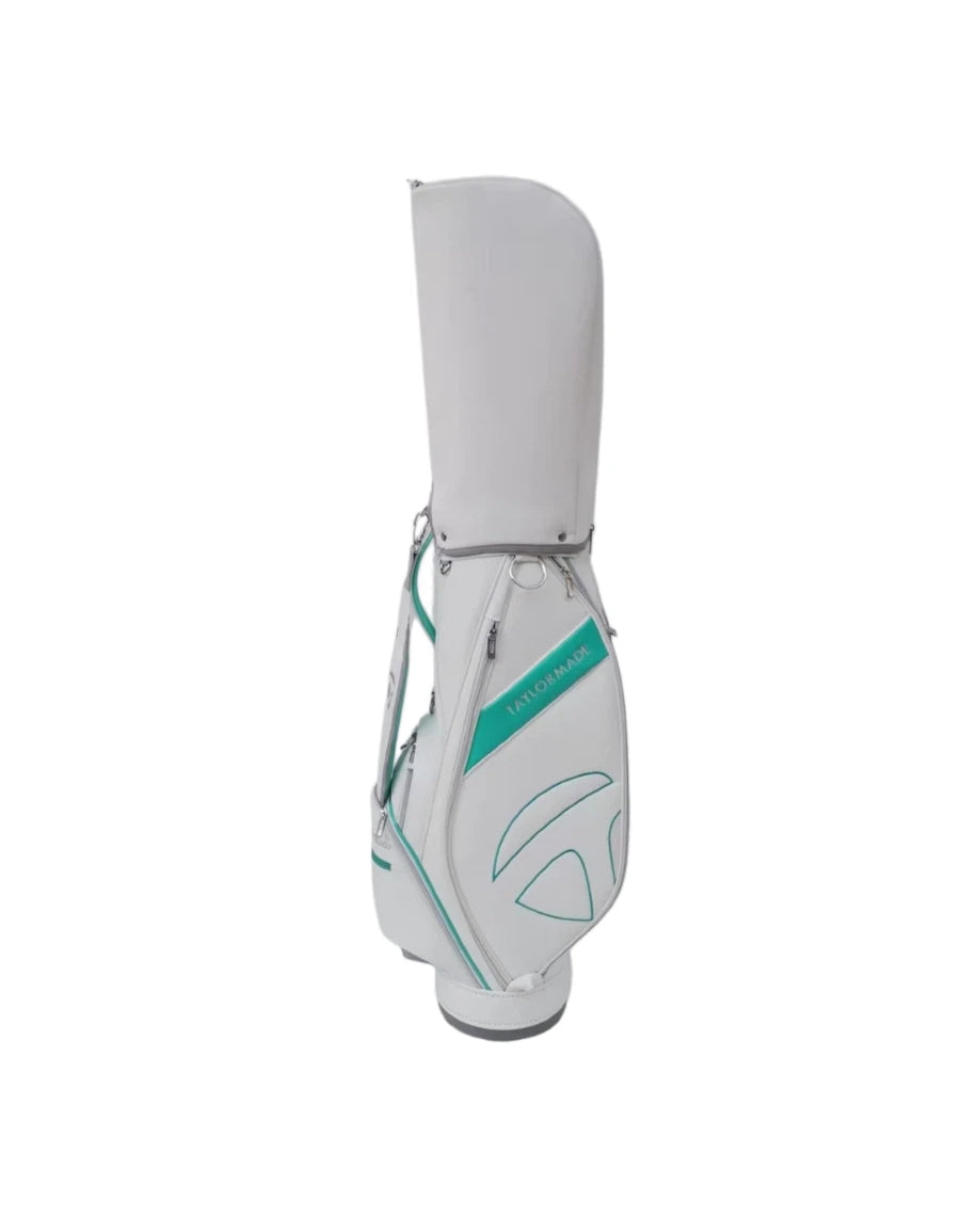 Side profile of the TaylorMade Concept One golf cart bag in white with teal trim and subtle embossed branding. Designed for both functionality and fashion, this bag features a padded shoulder strap, durable zippers, and a streamlined shape for easy carrying on the golf course.