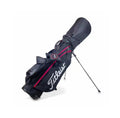 Side-angle view of the black Titleist carry golf bag with deployed stand legs, showcasing its lightweight frame, padded shoulder strap, and ergonomic design for comfortable carrying.