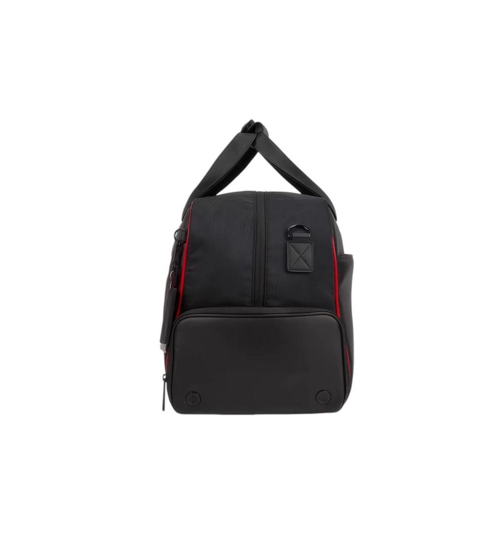 Rear view of the black Titleist Premium Golf Duffel with red piping details and protective bottom feet. Includes a branded leather tag and dual-carry handles for easy transport.