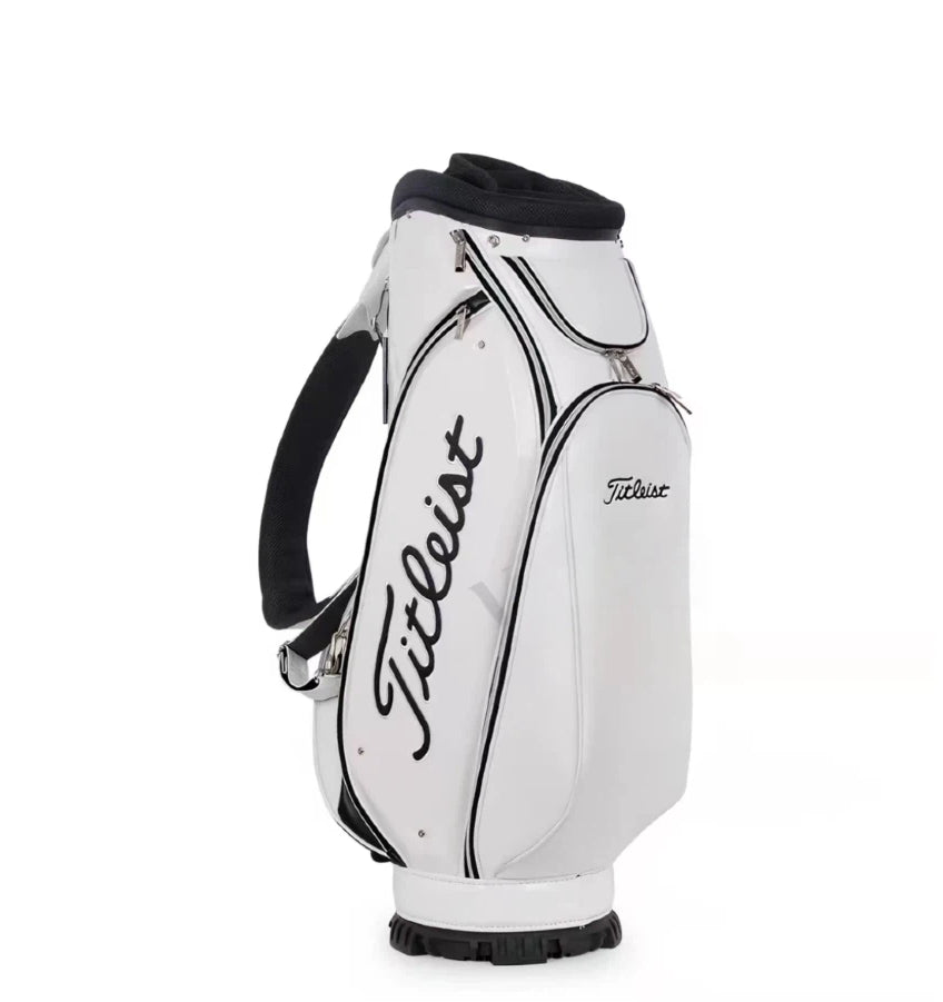Front view of the Titleist Standard Cart Bag in white with black trim. Features the iconic "Titleist" script logo, padded shoulder strap, reinforced base with rubber feet, and sleek design. Ideal for golfers seeking durability and style.
